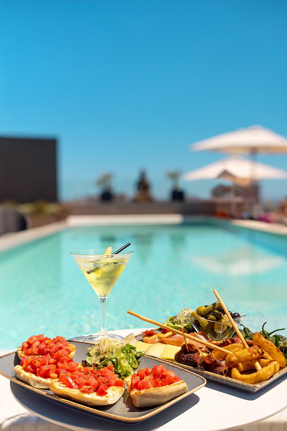 A drink and snacks beside the rooftop pool