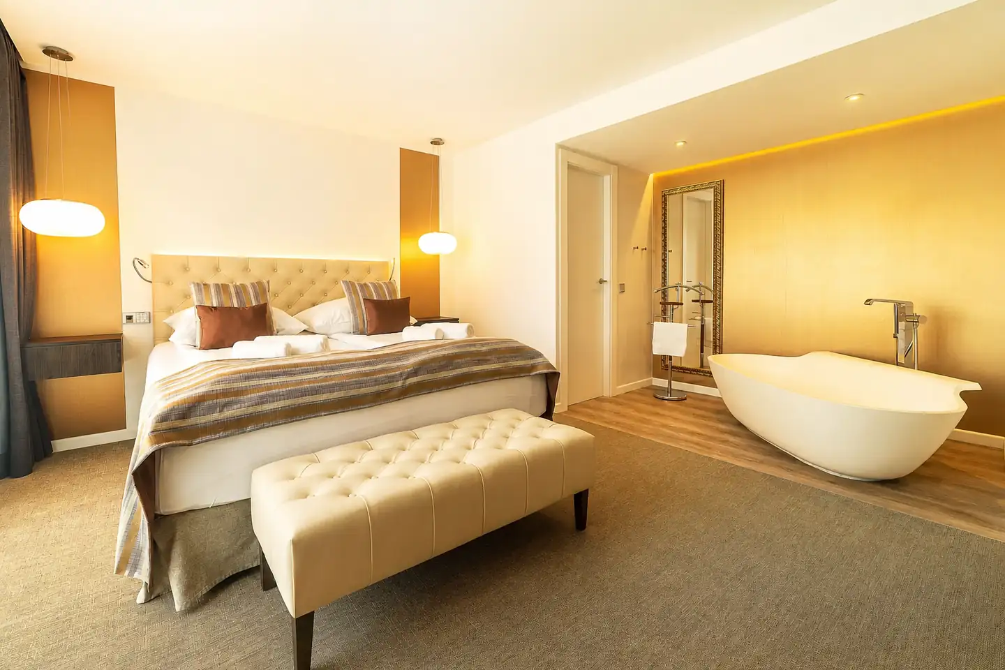 Suite with bathtub beside the bedroom
